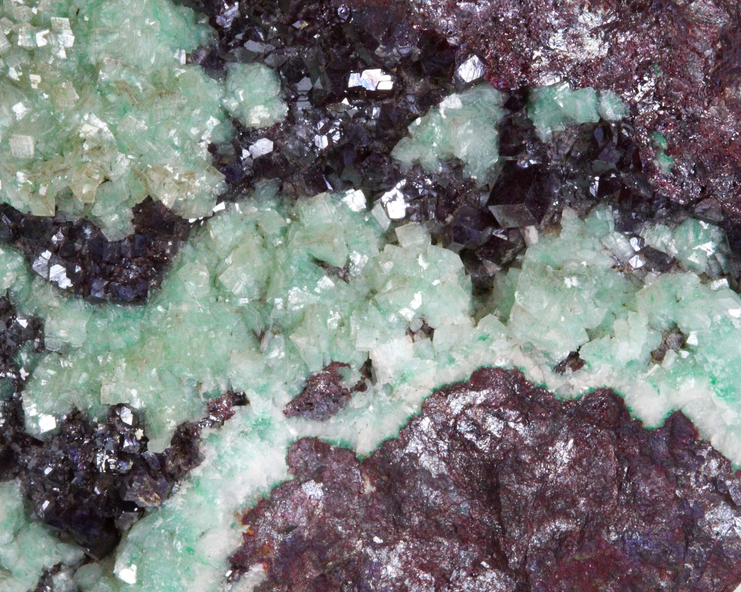 Calcite on Cuprite with Malachite inclusions